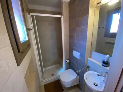 a bathroom with a shower and a toilet and a sink at Corallo Beach Front Apartments - By Bobbywashere in Santa Maria