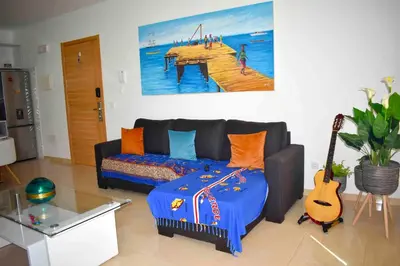 a living room with a couch and a guitar at Taninho in Santa Maria
