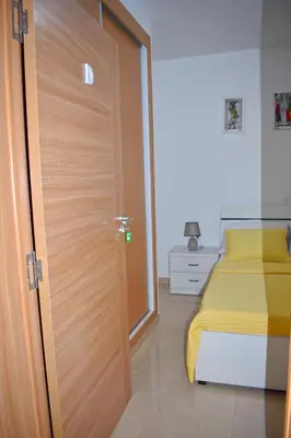 a door leading to a bedroom with a bed at Taninho in Santa Maria