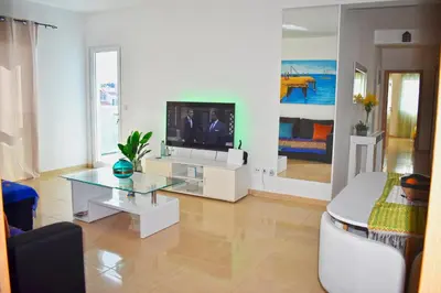 a living room with a television and a couch at Taninho in Santa Maria