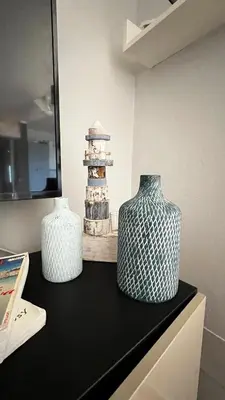 two vases sitting on top of a black counter at Tropical Morabeza Apartment Santa Maria in Santa Maria