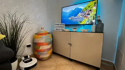 a tv sitting on top of a cabinet in a room at Tropical Morabeza Apartment Santa Maria in Santa Maria