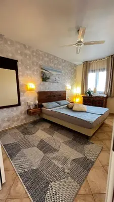 a bedroom with two beds and a mirror at Tropical Morabeza Apartment Santa Maria in Santa Maria