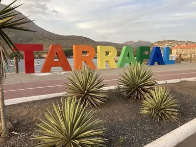 a large sign that saysarma inront of some plants at Hotel Viajante in Tarrafal