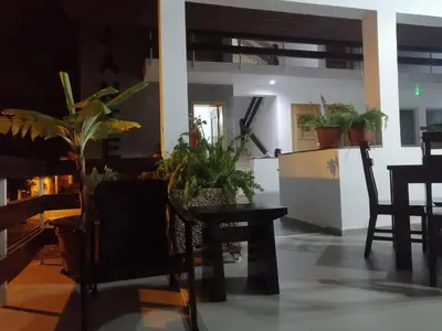 a dining room with a table and some plants at Hotel Viajante in Tarrafal