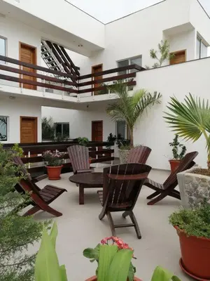 a patio with chairs and a table in a building at Hotel Viajante in Tarrafal