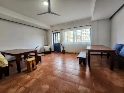 a living room with two tables and a couch at Txada Hostel in Praia