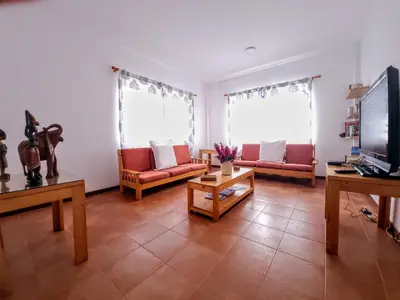 a living room with two couches and a tv at Txada Hostel in Praia