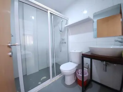 a bathroom with a shower and a toilet and a sink at Txada Hostel in Praia