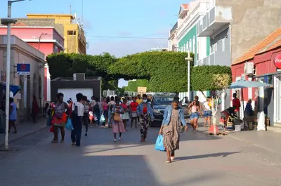 a group of people walking down a city street at Plateau Apartment in Praia
