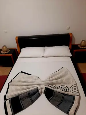 a white bed with a bow tie on it at SOL AZUL in Santa Maria