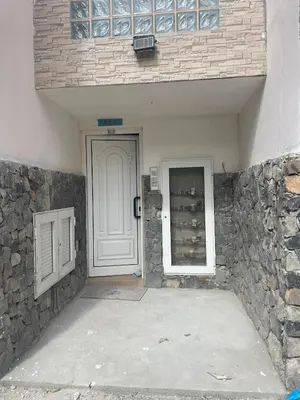 a white door in a building with a stone wall at SOL AZUL in Santa Maria