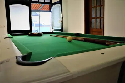 a pool table with a ball on top of it at Apartamento Mágico p/ momentos Memoráveis in Santa Maria