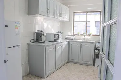 a kitchen with white cabinets and a white refrigerator at Apartamento Mágico p/ momentos Memoráveis in Santa Maria