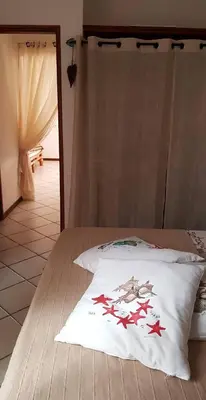 a bedroom with a bed with red stars on it at Appartamento Alma de Cri 10b, Sal Rei Estoril in Sal Rei