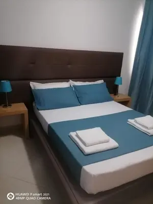 a bedroom with a blue bed with blue pillows at Solaren Apartments Boavista in Sal Rei