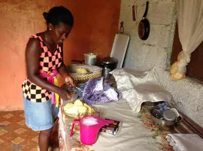 a woman standing in a kitchen preparing food at Kasa di Terra in Sacramento
