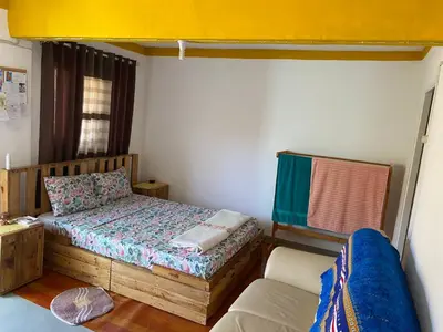 a small bedroom with a bed and a couch at Kasa di Terra in Sacramento