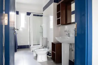 a bathroom with a toilet and a sink at Casa Branca Beach in Santa Maria