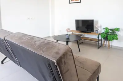 a living room with a couch and a table at Casa Branca Beach in Santa Maria