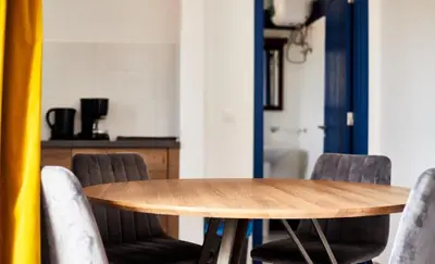 a wooden table and chairs in a room at Casa Branca Beach in Santa Maria