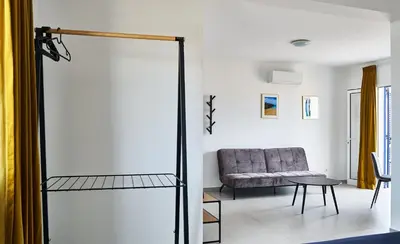 a living room with a couch and a chair at Casa Branca Beach in Santa Maria