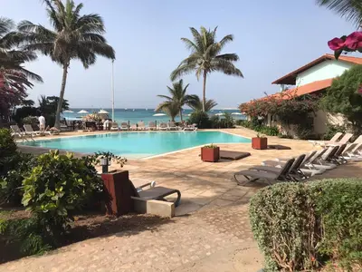 a pool with chairs and the ocean in the background at studio's Porto Antigo 2 in Santa Maria