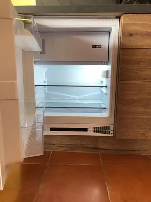 an empty refrigerator with its door open in a kitchen at studio's Porto Antigo 2 in Santa Maria