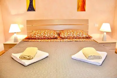 a large bed with two pillows and towels on it at Prostorný a pohodlný apartmán na pláži Cabral in Sal Rei