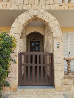 an entrance to a building with a wooden gate at Prostorný a pohodlný apartmán na pláži Cabral in Sal Rei