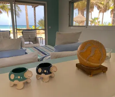 two stuffed animals sitting on a table in a living room at Vila Mare - Praia de Chaves frontline in Cabeçadas