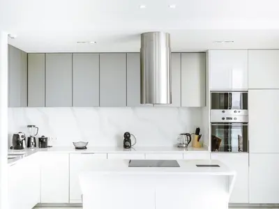 a white kitchen with white cabinets and appliances at Filomena Apartments LUXURY in Mindelo