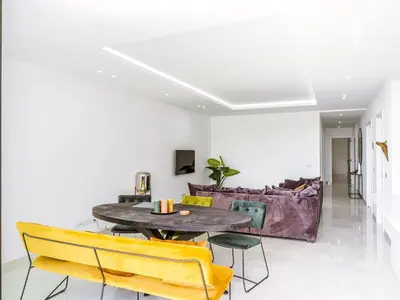 a dining room with a table and yellow chairs at Filomena Apartments LUXURY in Mindelo