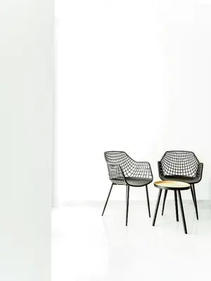 three chairs and a table in a white room at Filomena Apartments LUXURY in Mindelo