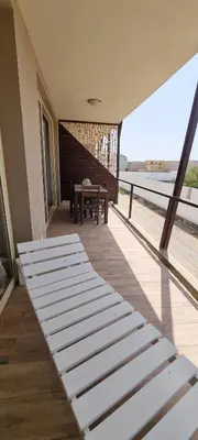 a room with two beds and a table on a balcony at Casa Visto Mar in Sal Rei