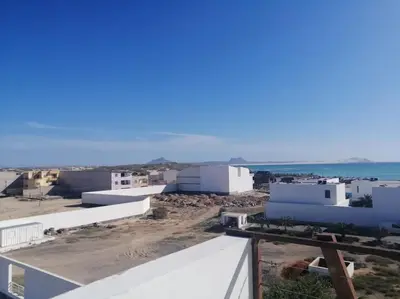 a view of a group of white buildings and the ocean at Casa Visto Mar in Sal Rei