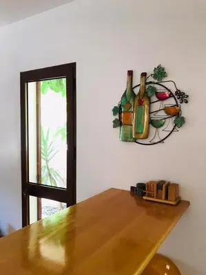 a room with a table with bottles on the wall at Residencial Lela d'Fermina in Pombas