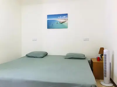 a bedroom with a bed and a picture on the wall at Residencial Lela d'Fermina in Pombas