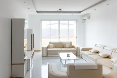 a living room with white furniture and a table at 3 bedroom apt, Exterior POOL , Cidadela - LCGR in Praia