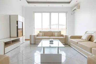 a living room with a couch and a table at 3 bedroom apt, Exterior POOL , Cidadela - LCGR in Praia