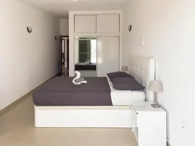 a bedroom with two beds and a swan on the bed at 3 bedroom apt, FREE WIFI & AC, Cidadela - LCGR in Praia