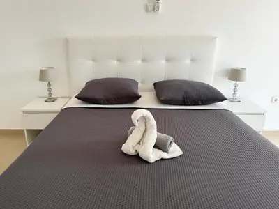 a stuffed animal is sitting on a bed at 3 bedroom apt, FREE WIFI & AC, Cidadela - LCGR in Praia
