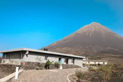 a building with a mountain in the background at Casa Ze & sonia in Portela