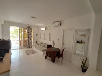 a living room with a couch and a table at Praia de Chaves Bungalow ,Boavista in Sal Rei