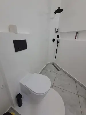 a bathroom with a white toilet in a room at Praia de Chaves Bungalow ,Boavista in Sal Rei
