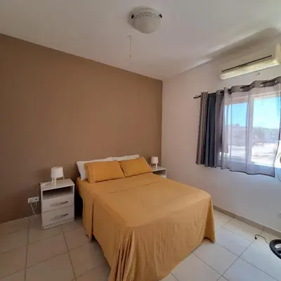 a bedroom with a bed with yellow sheets and a window at Ca Luna Deluxe sun & Beach in Sal Rei