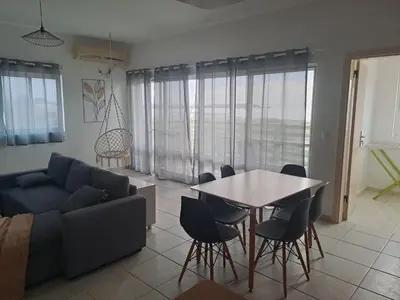 a living room with a couch and a table and chairs at Ca Luna Deluxe sun & Beach in Sal Rei