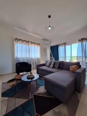 a living room with a couch and a table at Ca Luna Deluxe sun & Beach in Sal Rei