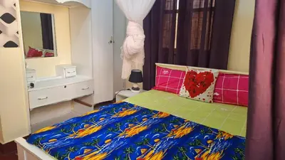 a bedroom with a bed with a colorful blanket at Casa de Férias in Tarrafal