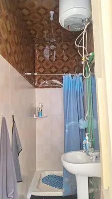 a bathroom with a sink and a toilet and a shower at Casa de Férias in Tarrafal